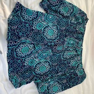Navy and Green floral, 100% polyester. Off-the-shoulder, torrid top.